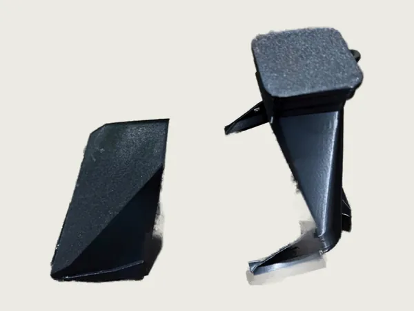 The two printed hood parts, a base with camera cap and a front cover, lying side by side